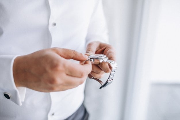 a man adjusting his watch